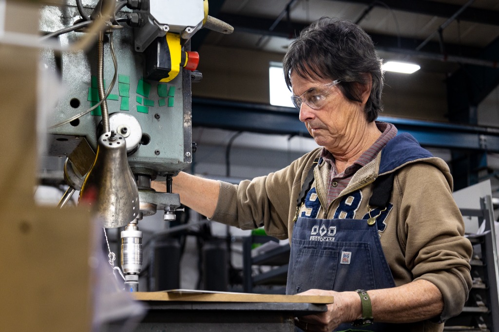 Skilled Protocase operator working on a drill press